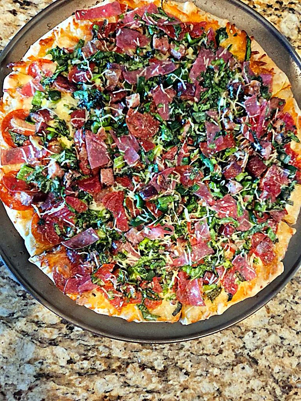 Pizza loaded with peppers and spinach